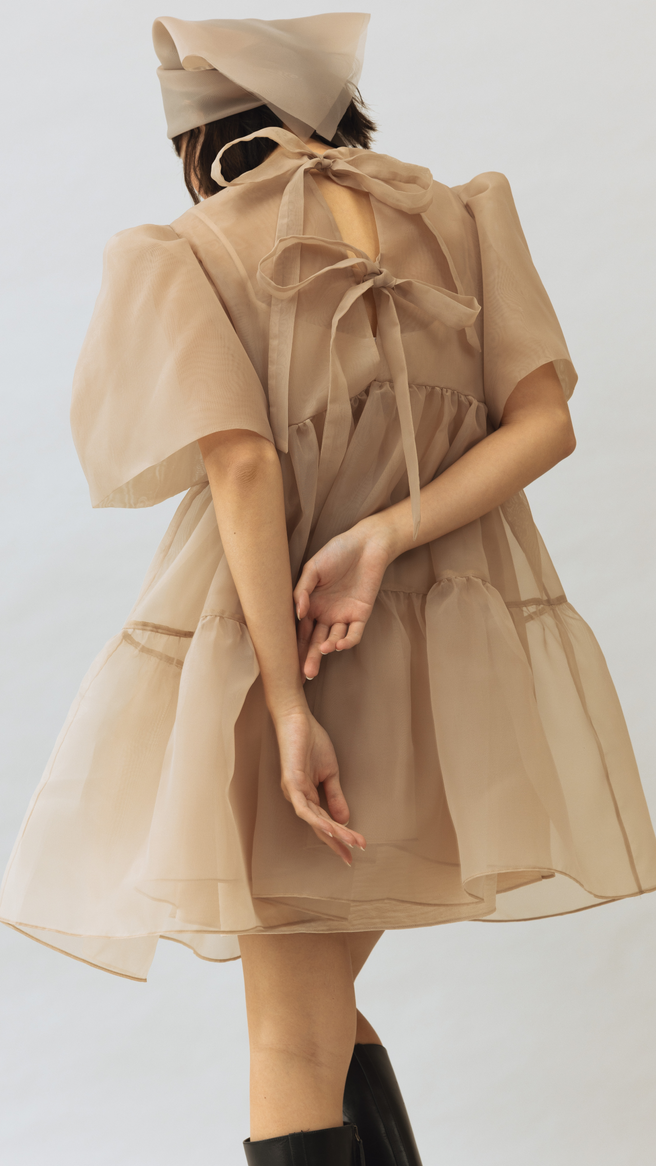 Sally wears The Camisa Babydoll Dress in nude