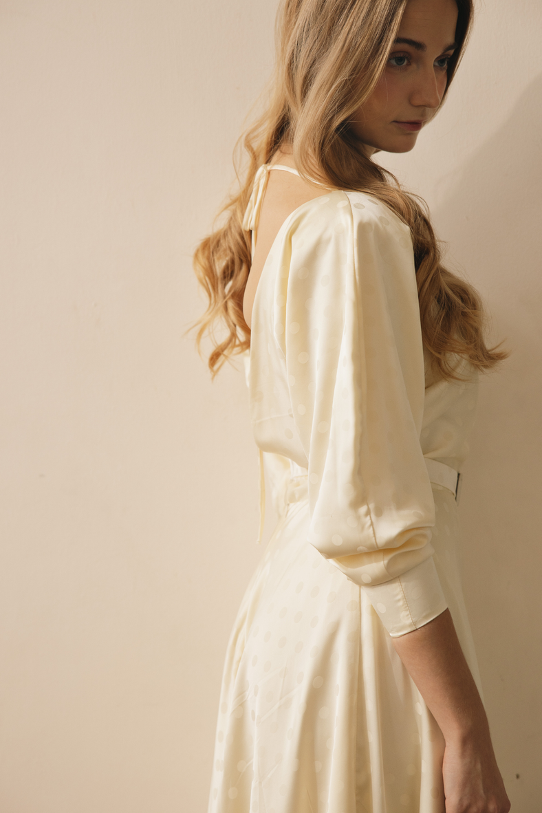 Vania Romoff Helen Dress in cream polka dot polka-dot print, features a Sabrina neckline, padded dolman sleeves and and is cinched at the waist 