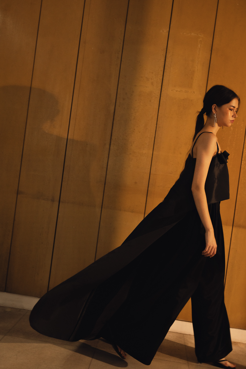 Vania Romoff The Nancy Top in black is crafted in crisp taffeta and features a high–low hem