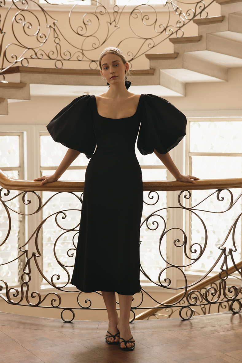  Vania Romoff Sigrid dress in black is a flattering midi dress is framed with voluminous puff sleeves 
