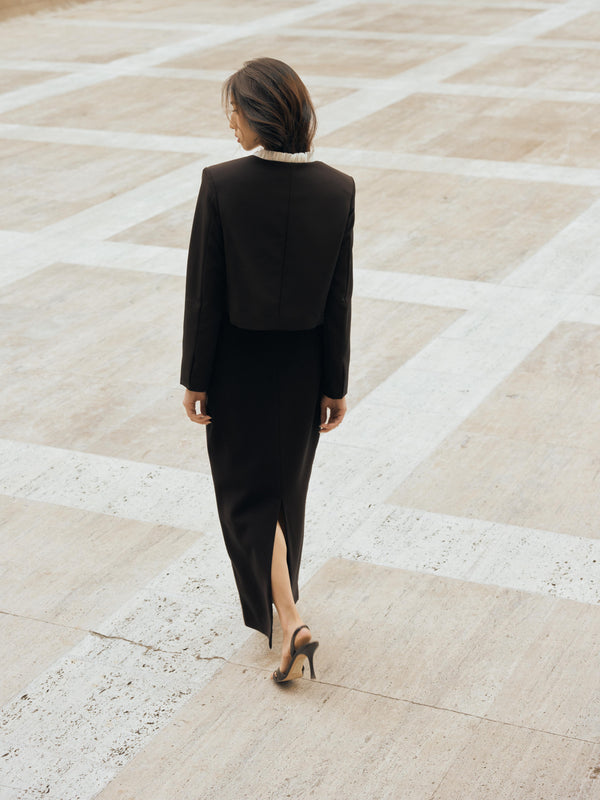 Vania Romoff The Ada Jacket in black and white features a structured silhouette in black neocrepe. Contrasting white trim frames the neckline 