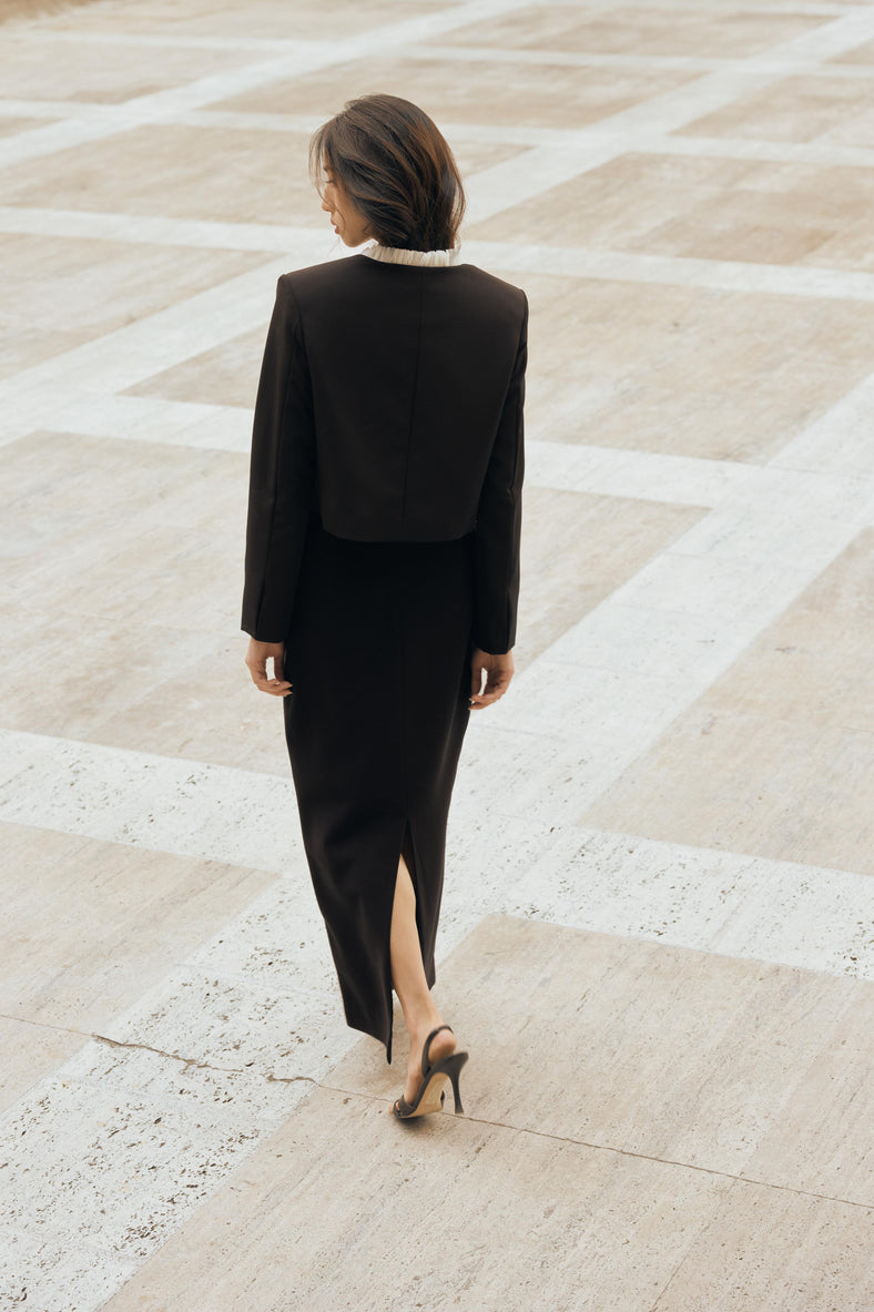 Vania Romoff The Ada Jacket in black and white features a structured silhouette in black neocrepe. Contrasting white trim frames the neckline 