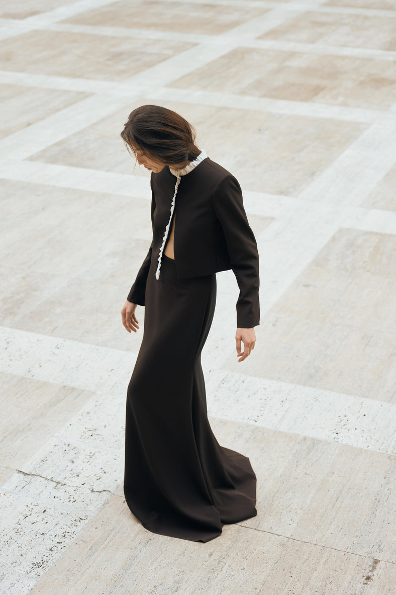 Vania Romoff The Ada Jacket in black and white features a structured silhouette in black neocrepe. Contrasting white trim frames the neckline 