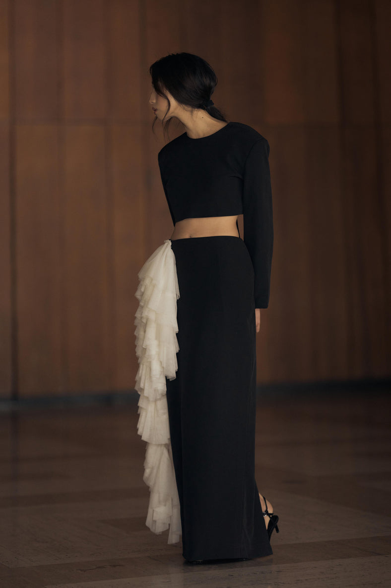 Vania Romoff The Alma Skirt features a sleek, floor-length silhouette in black neocrepe