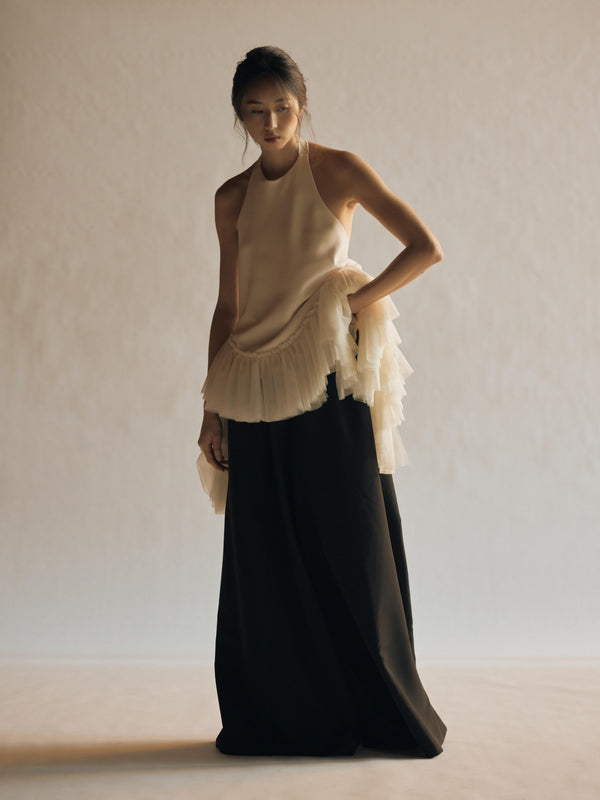  Vania Romoff The Clara Top in ivory features a halter neckline and a relaxed, flowing silhouette in ivory stretch crepe