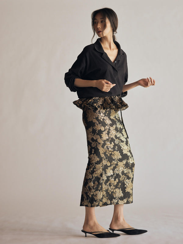 Vania Romoff The Cordelia Skirt with peplum in black with gold florals features a sleek, midi-length silhouette in black jacquard organza, adorned with intricate gold florals