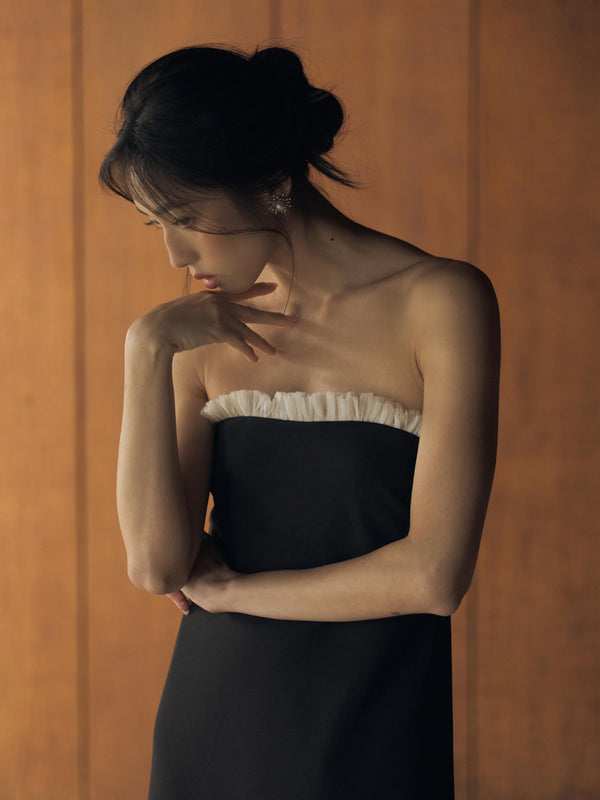 Vania Romoff The Helene Dress  in black features a sleek, strapless silhouette in black neocrepe, with a contrasting ivory trim along the neckline