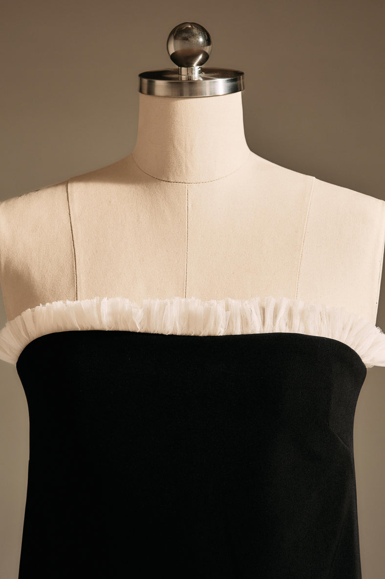 Vania Romoff The Helene Dress  in black features a sleek, strapless silhouette in black neocrepe, with a contrasting ivory trim along the neckline