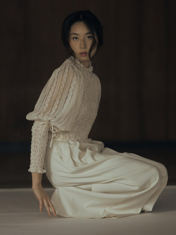 Vania Romoff The Juliet Top in oat is crafted from delicate lace and features intricate ruching, a high neckline, and sheer sleeves