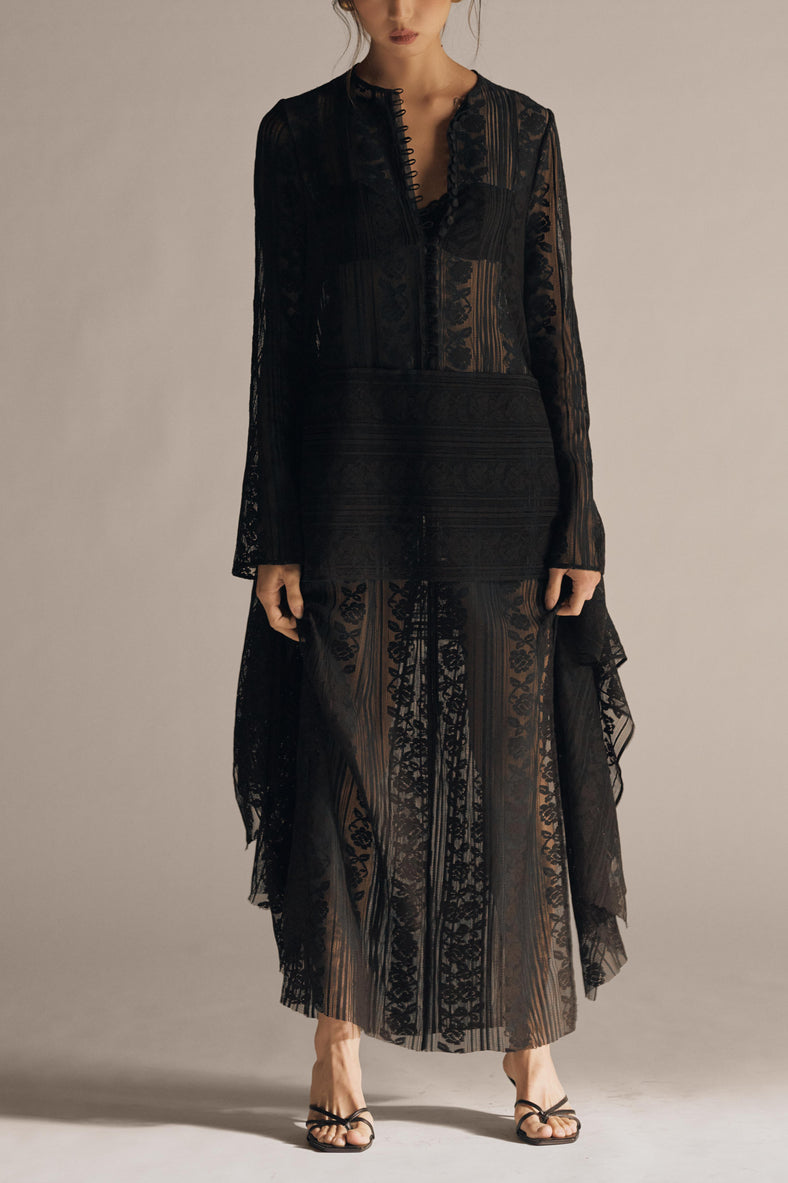 Vania Romoff The Ruth Dress in black  features delicate black floral lace, a plunging neckline, and long sleeves