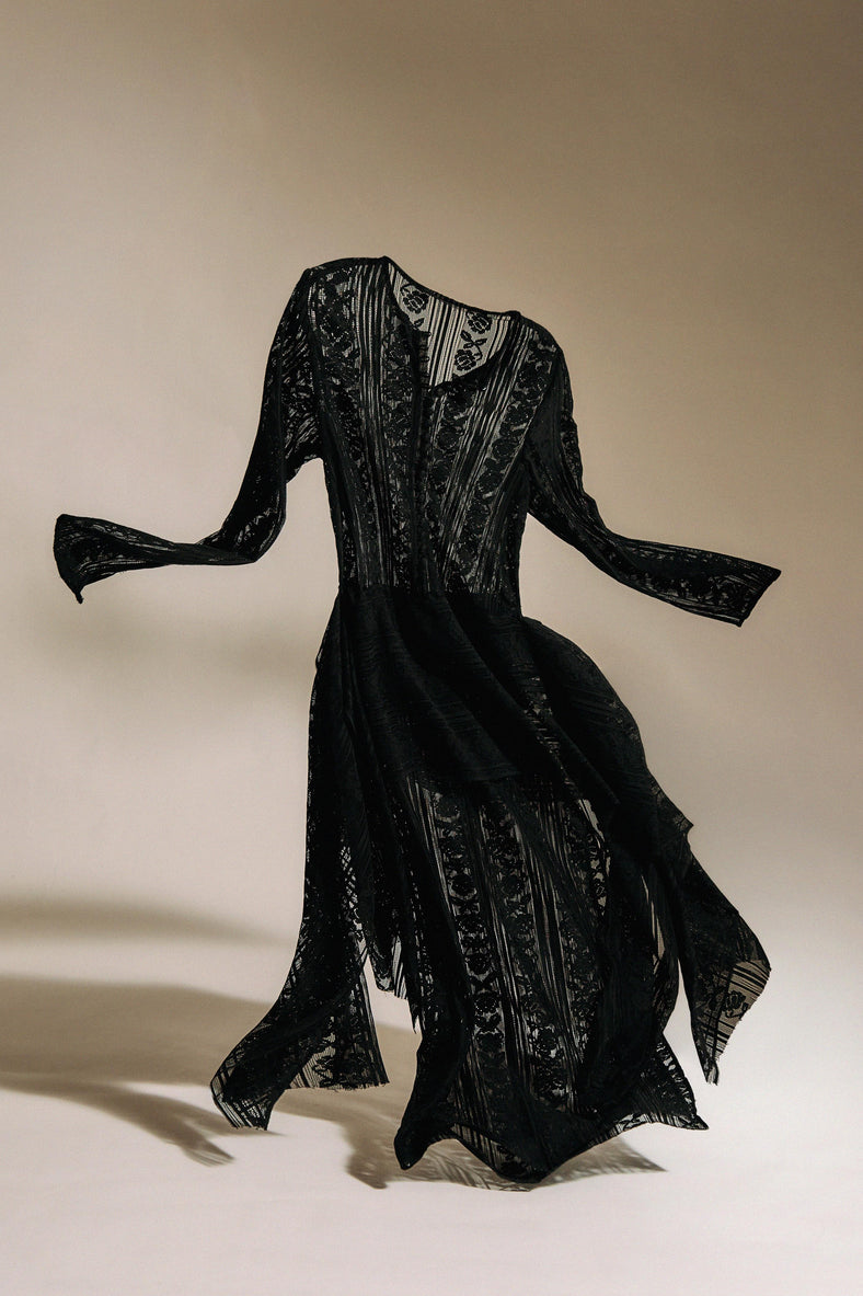 Vania Romoff The Ruth Dress in black  features delicate black floral lace, a plunging neckline, and long sleeves