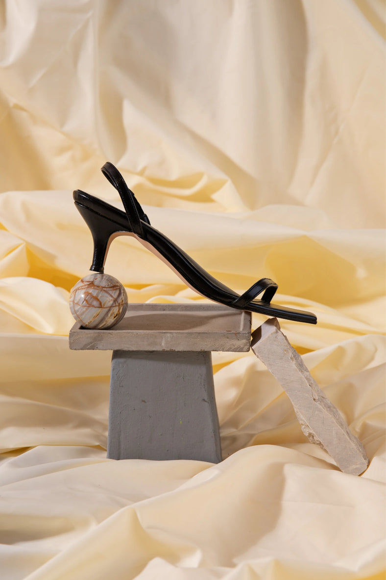 Vania Romoff The Two strap Sandal in black is a sleek square-toe silhouette with slender interlocking straps